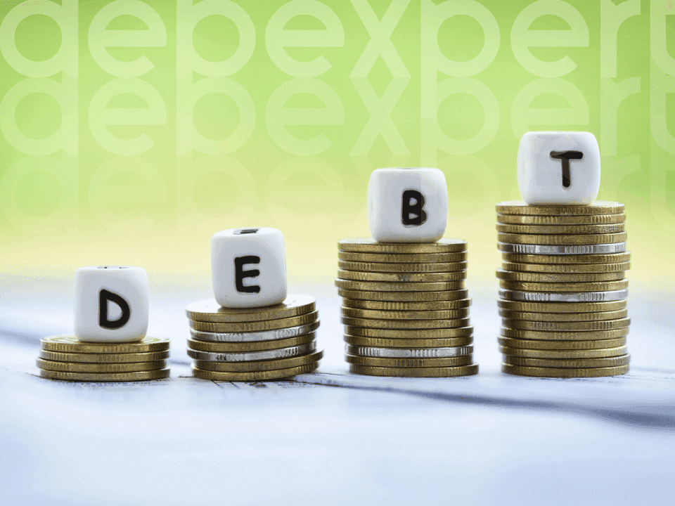 6501b46e488c2835816c4404_Coins-and-cubes-with-the-word-debt.png